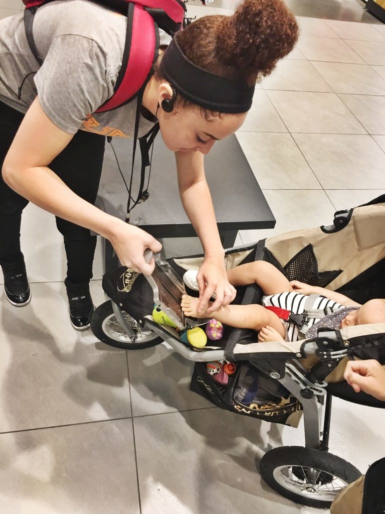 Baby getting fitted for shoes at footlocker 