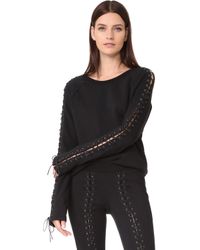 Lisa Rinna's Black Lace Up Sweatsuit