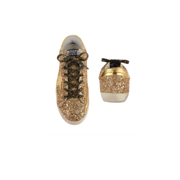 Tinsley Mortimer's Gold Glitter Sneakers and Ripped Tee