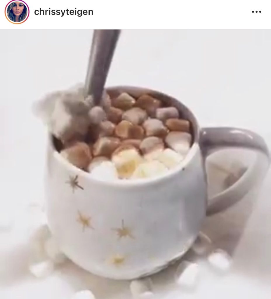 Chrissy Teigen's White Mug With Gold Stars Making Hot Cocoa 