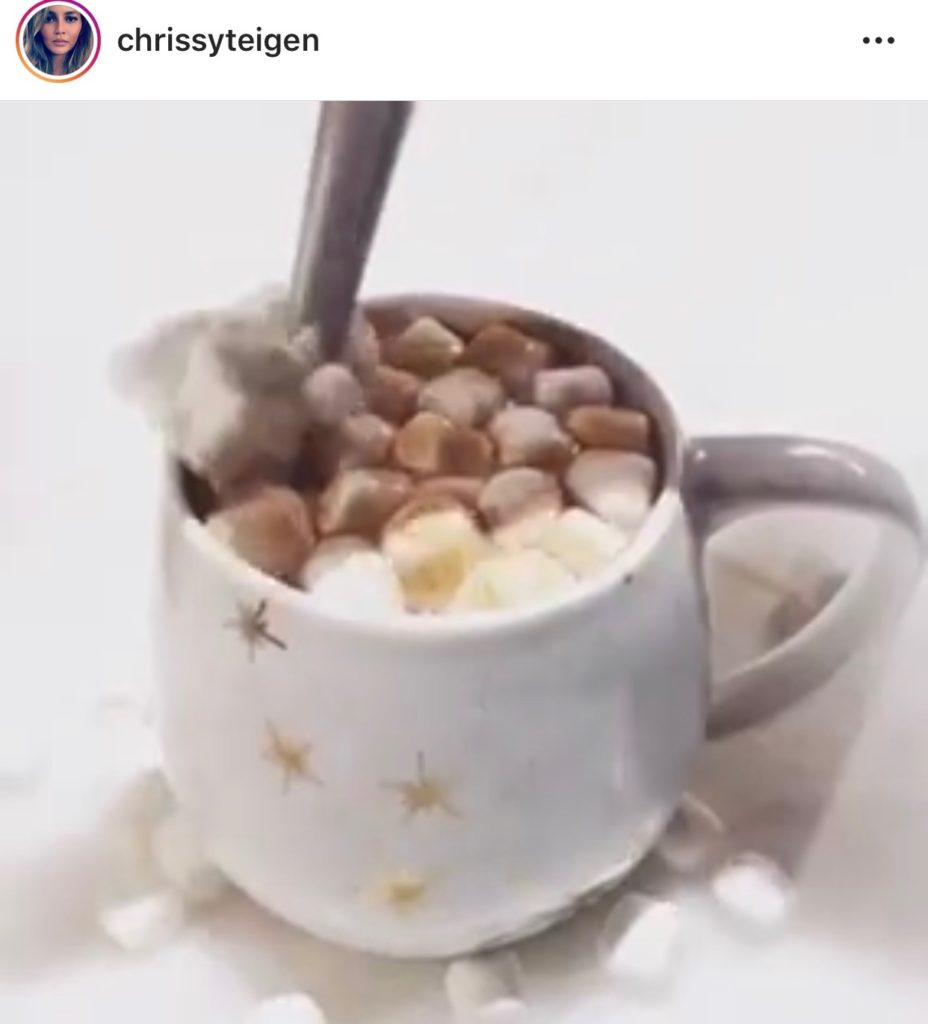 Chrissy Teigen's White Mug With Gold Stars Making Hot Cocoa