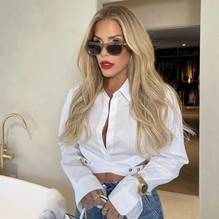 Tracy Tutor’s White Belted Cropped Shirt and Clear Sunglasses
