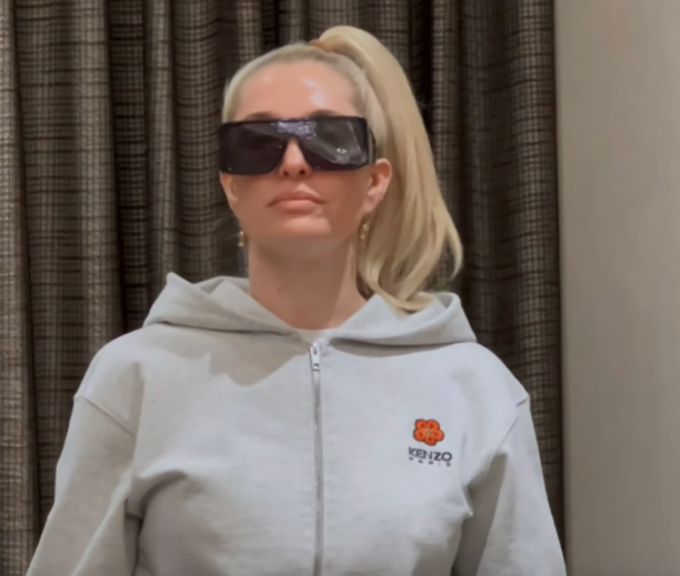 Erika Girardi's Grey Zip Up and Black Sunglasses